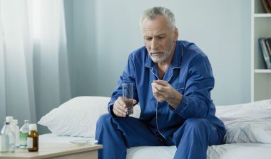 Older man taking medication