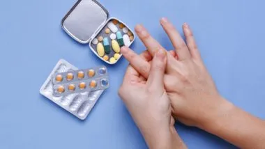 close up of person hands taking gout medication