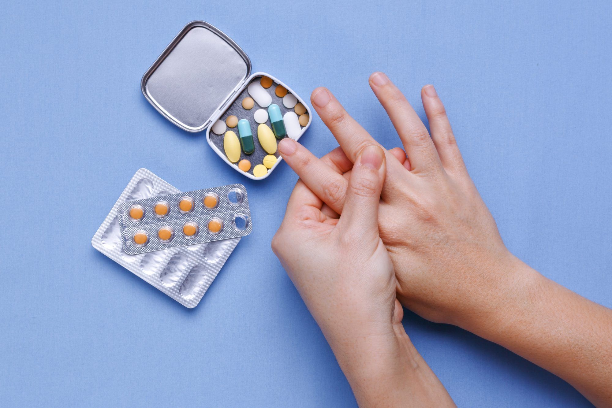 close up of person hands taking gout medication