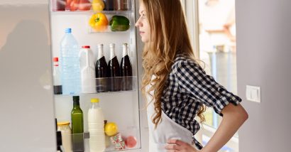 woman looking into Whirlpool refrigerator