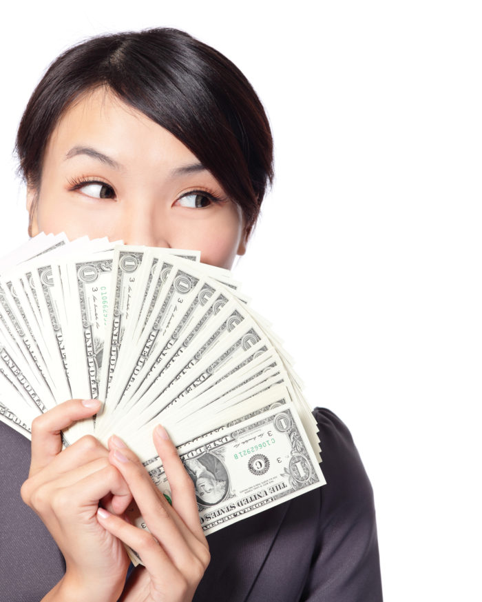 woman holding money she receiving in the mail from an FTC refund