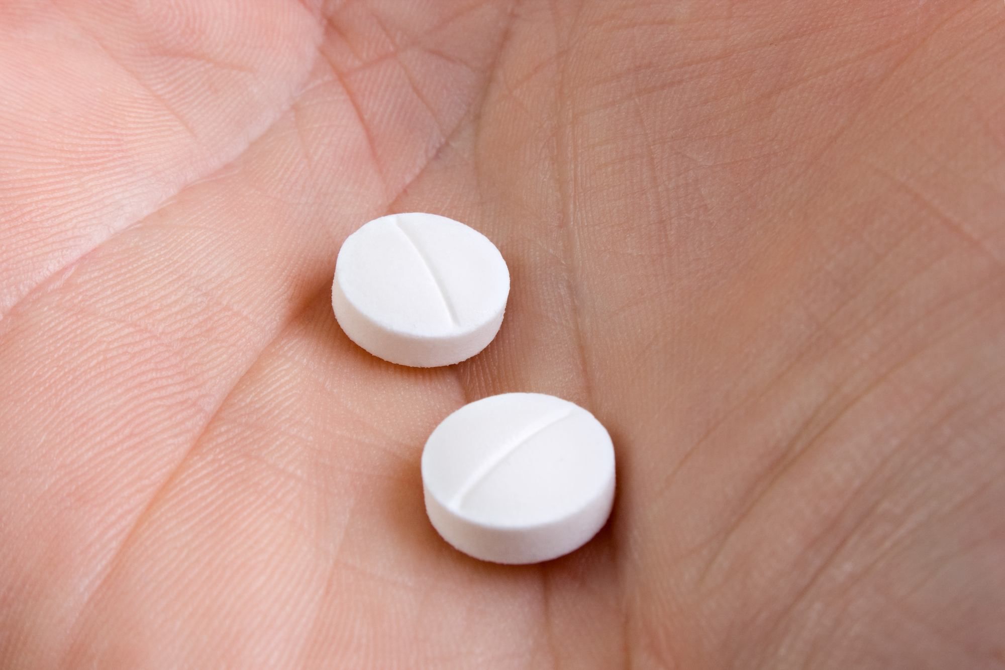 Hand with two medicine pills