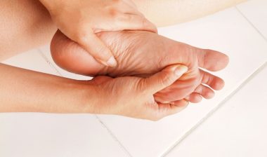 Woman checks her aching foot