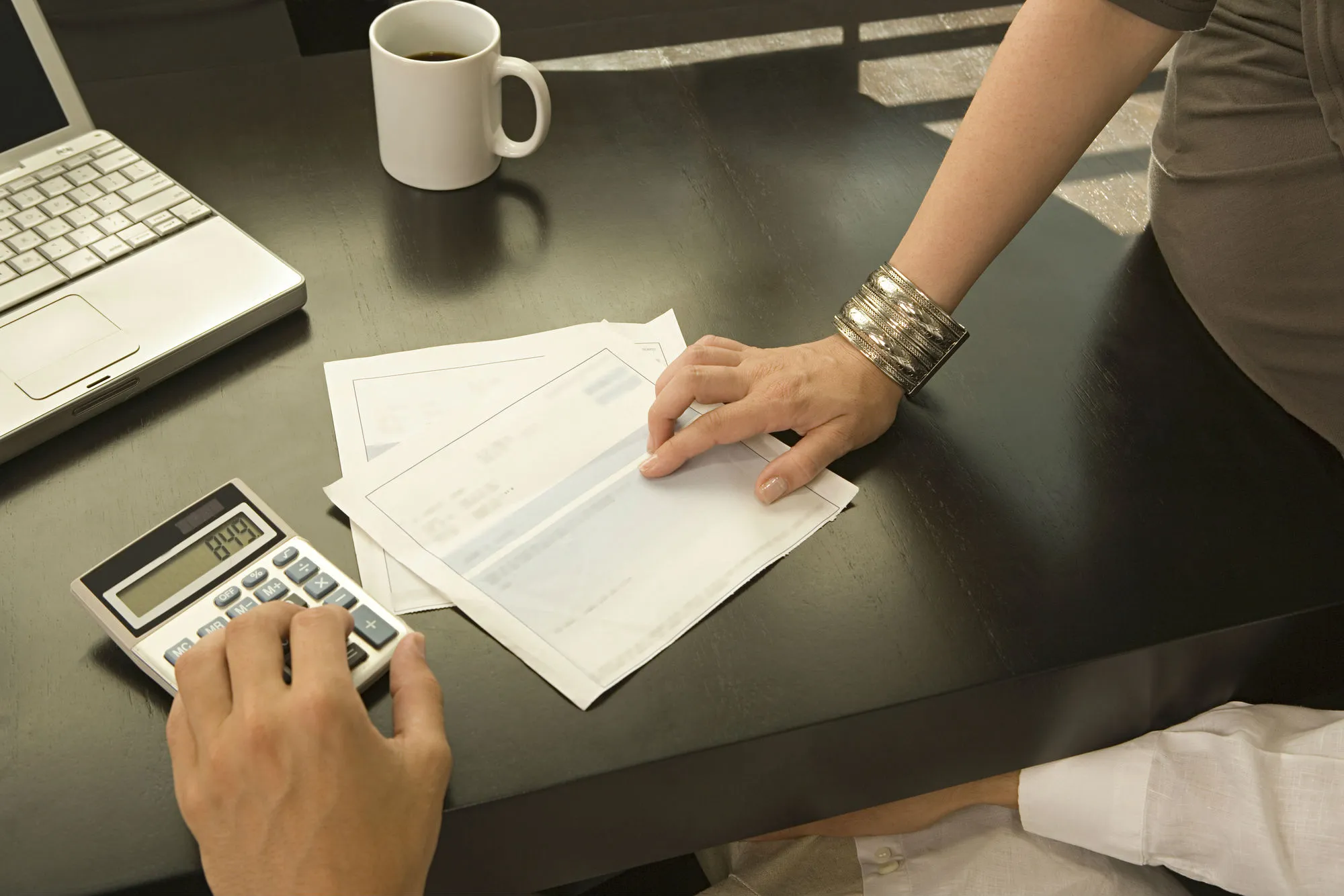 A couple work on their bank statement.