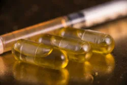 CBD capsules and syringe