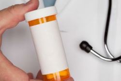 Doctor holding pill bottle