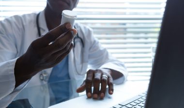 Doctor with pill bottle