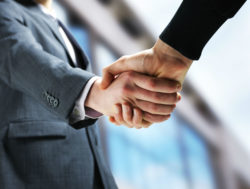 Two lawyers shake hands.