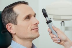 eye doctor looking at patient eyes