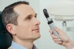 eye doctor looking at patient eyes
