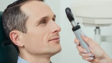 eye doctor looking at patient eyes