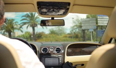 man using bluetooth in car