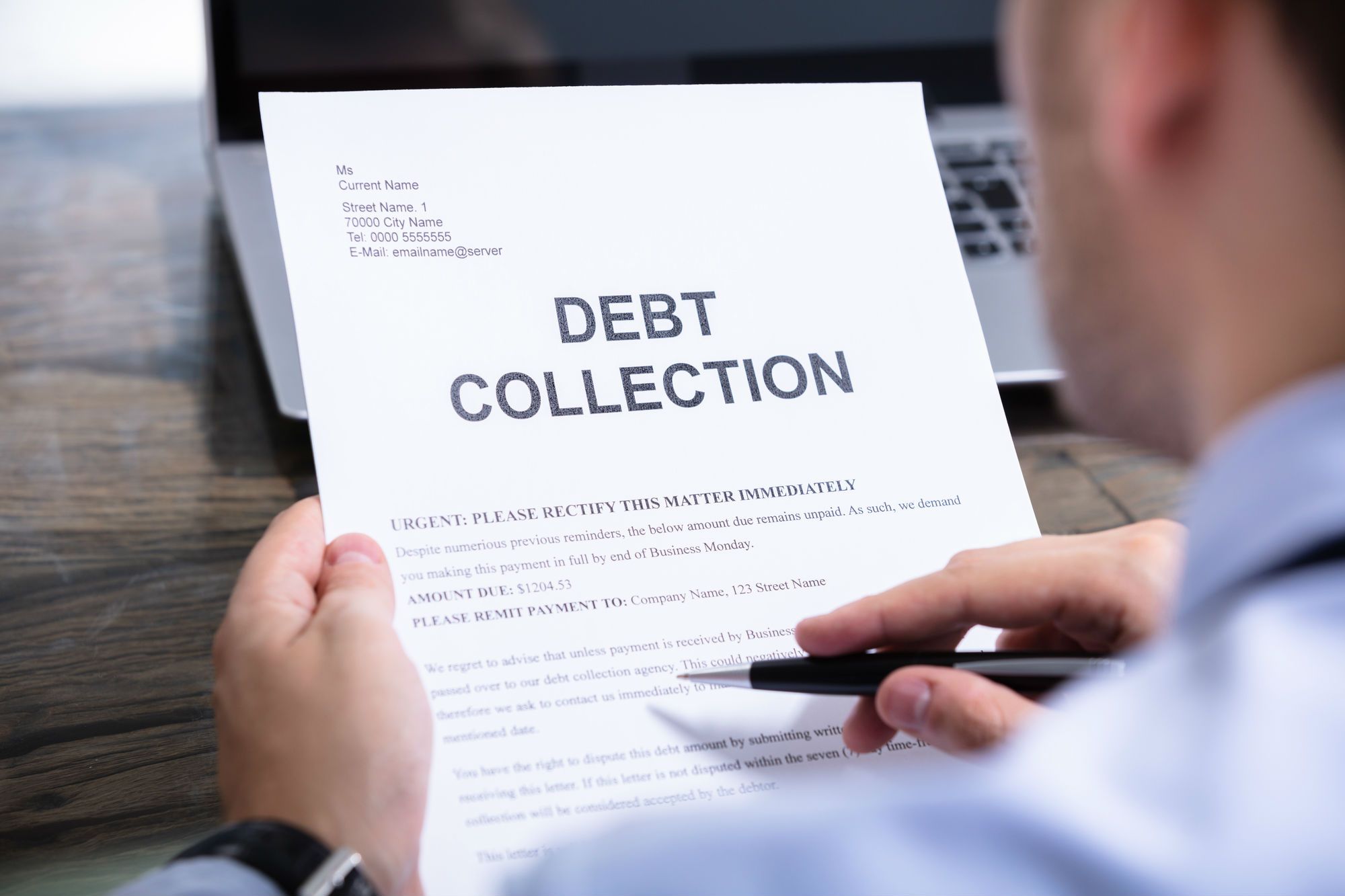 Man reads debt collection notice