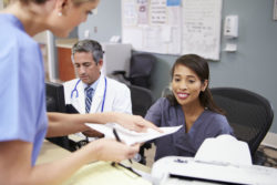 Nurses and doctors handling medical records