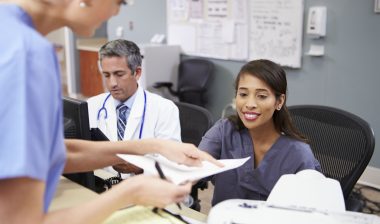 Nurses and doctors handling medical records
