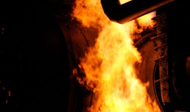 A fire burns around a pipeline.