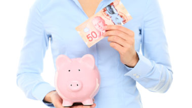 woman holding canadian currency from class action rebates
