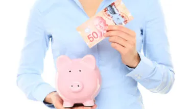 woman holding canadian currency from class action rebates