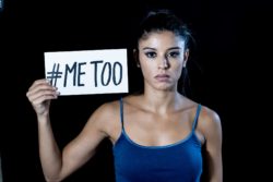 young woman holding me too sign