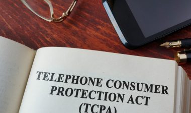 Book with TCPA on wood desk