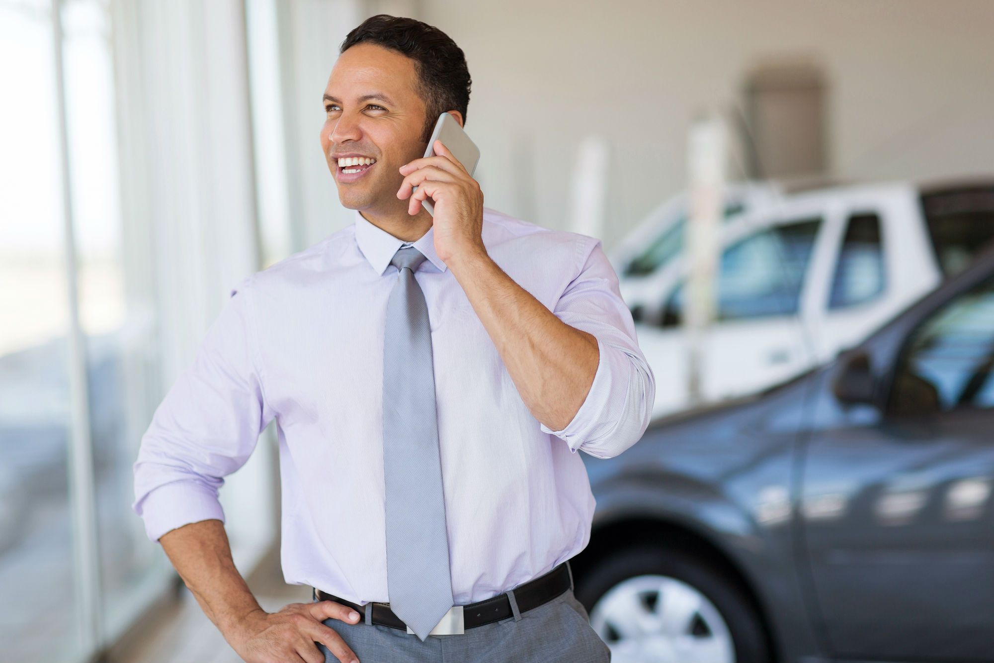 Car dealer on cell phone