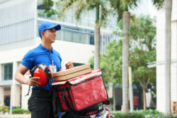 A man delivers pizza.