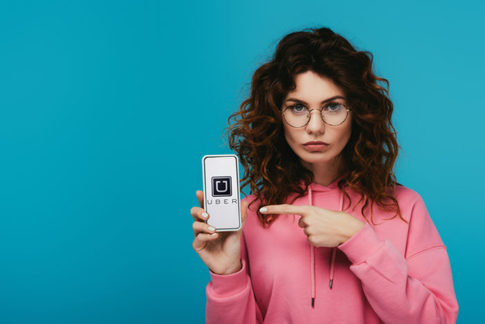 woman with uber app on smartphone