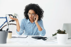 A frustrated woman talks on the phone.