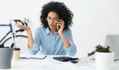 A frustrated woman talks on the phone.