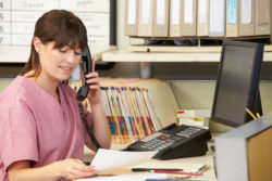 A nurse talks on a phone.