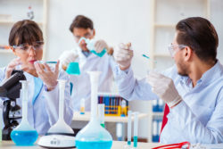 Three technicians conduct pharmaceutical research.