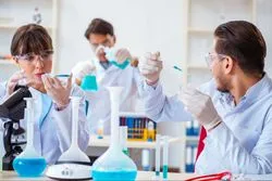 Three technicians conduct pharmaceutical research.