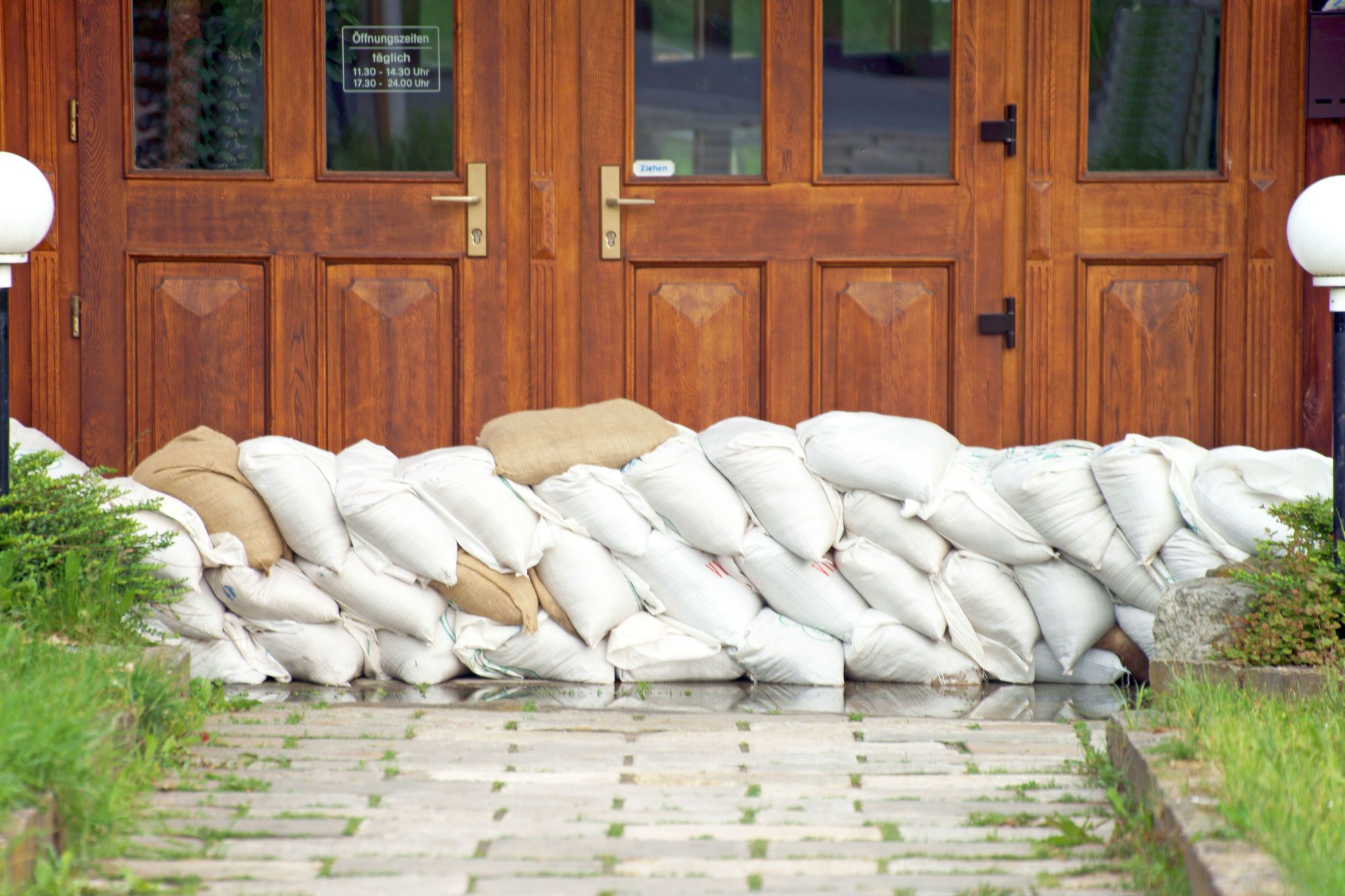 Sandbags are placed against doors before a flood.