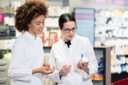 Two pharmacists read a label.