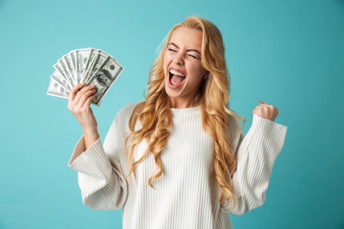 woman holding money from class action rebates