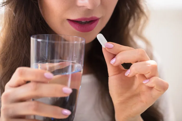 woman taking supplement