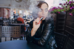 Young woman vaping