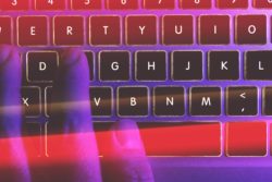 Fingers typing on laptop