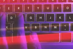 Fingers typing on laptop