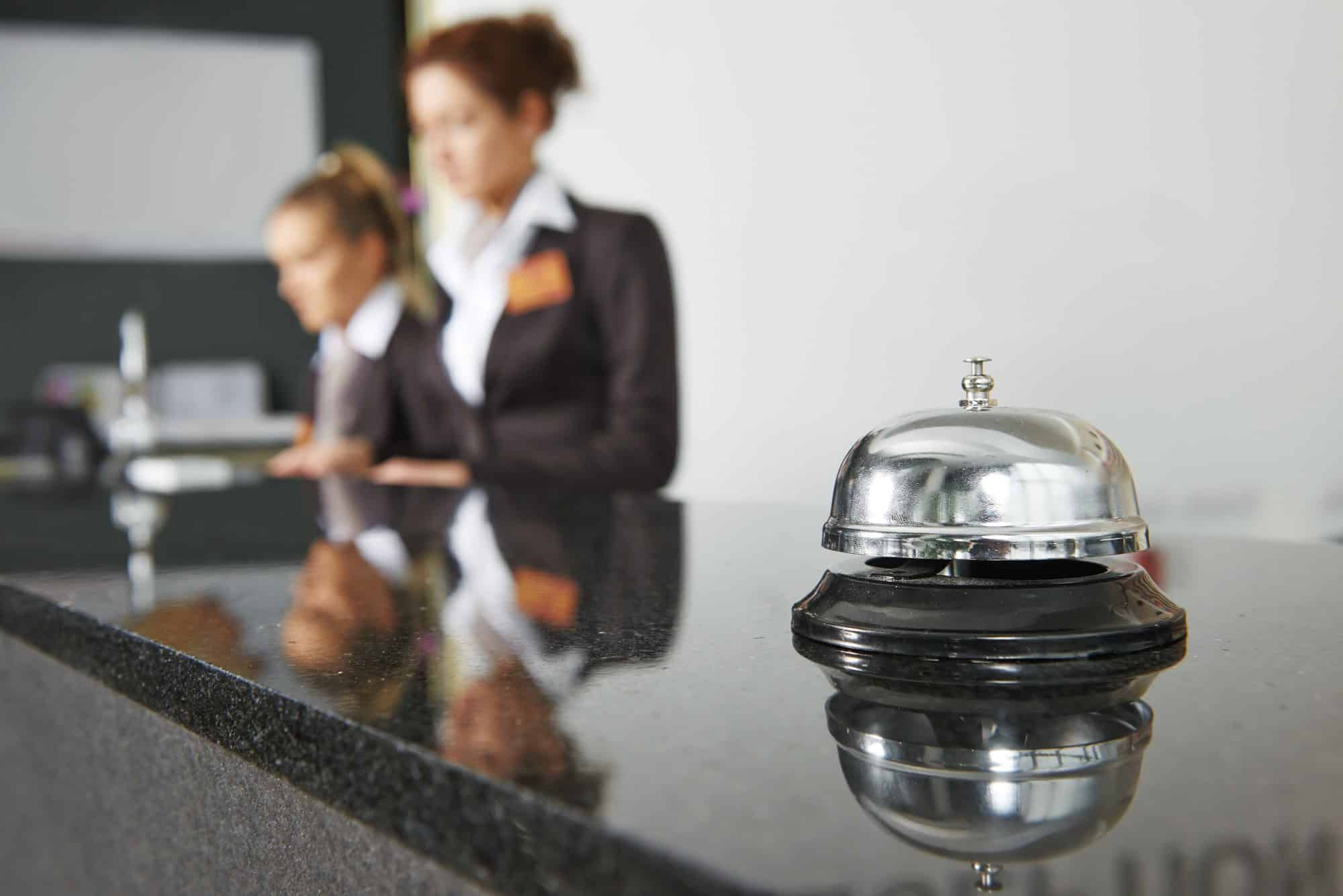 Hotel lobby with blurred image of two front desk workers in the background - prosecuted for sex trafficking