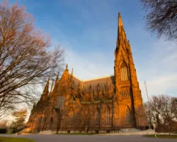 The sun goes down outside a church.