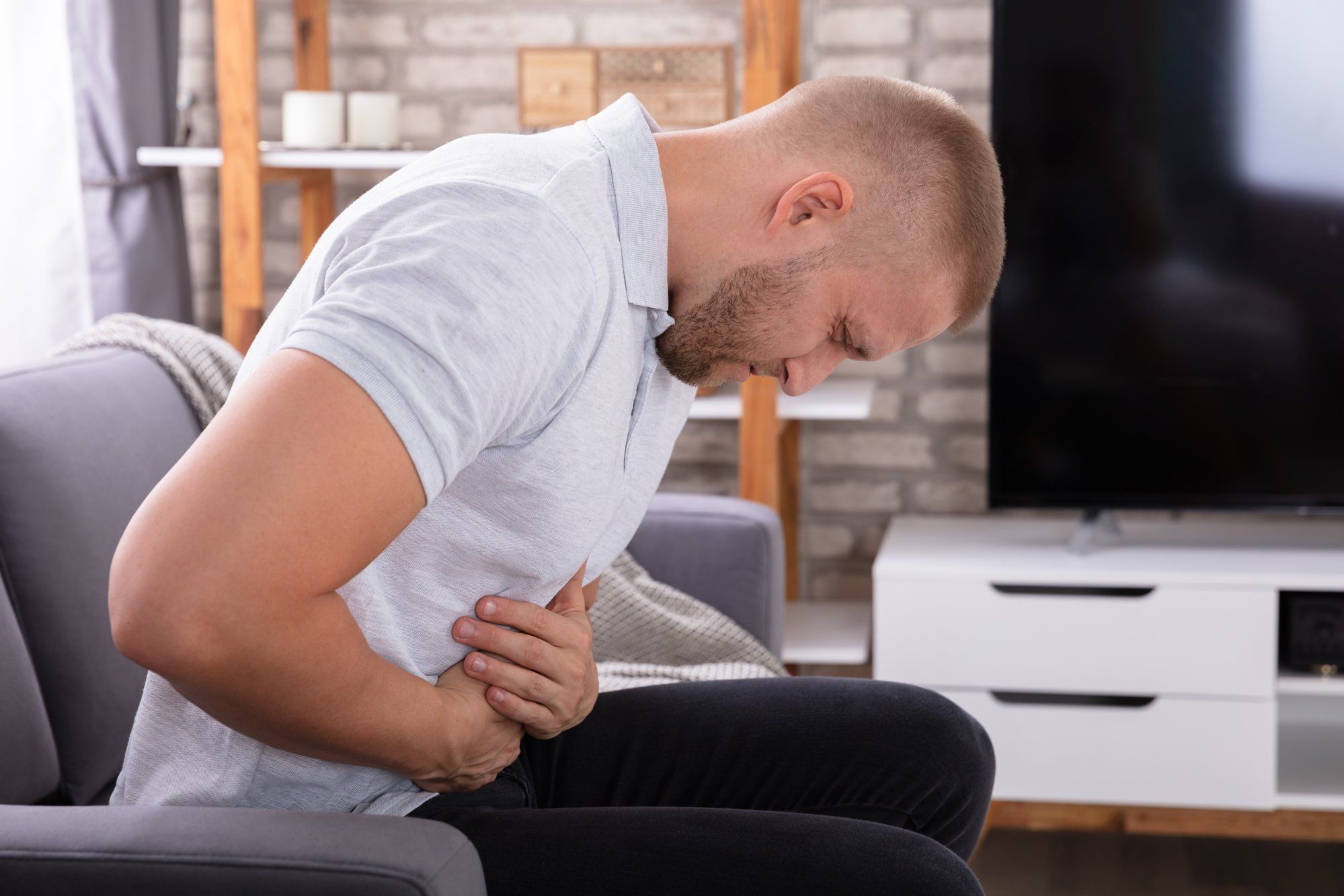 man suffering from stomach pain or heartburn