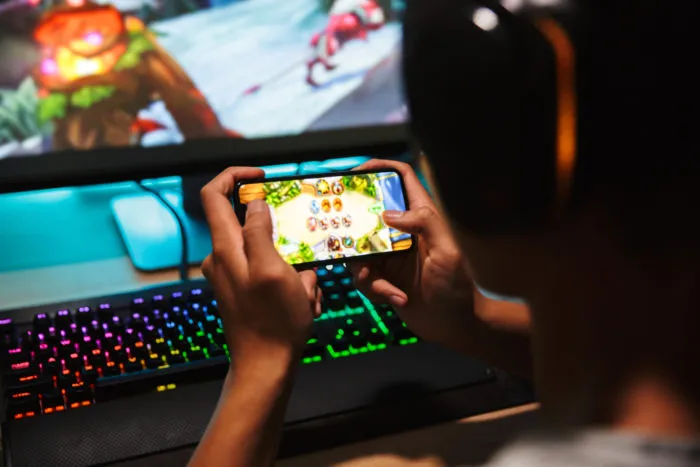 man playing rise of kingdoms on phone