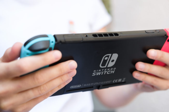 kid holding nintendo switch