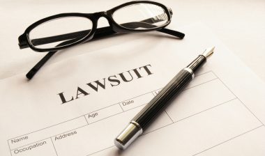 Pen, glasses, lawsuit form