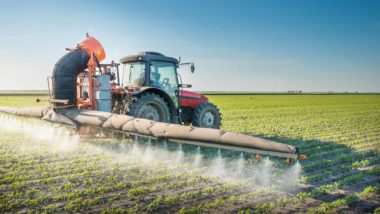 Tractor spraying crops