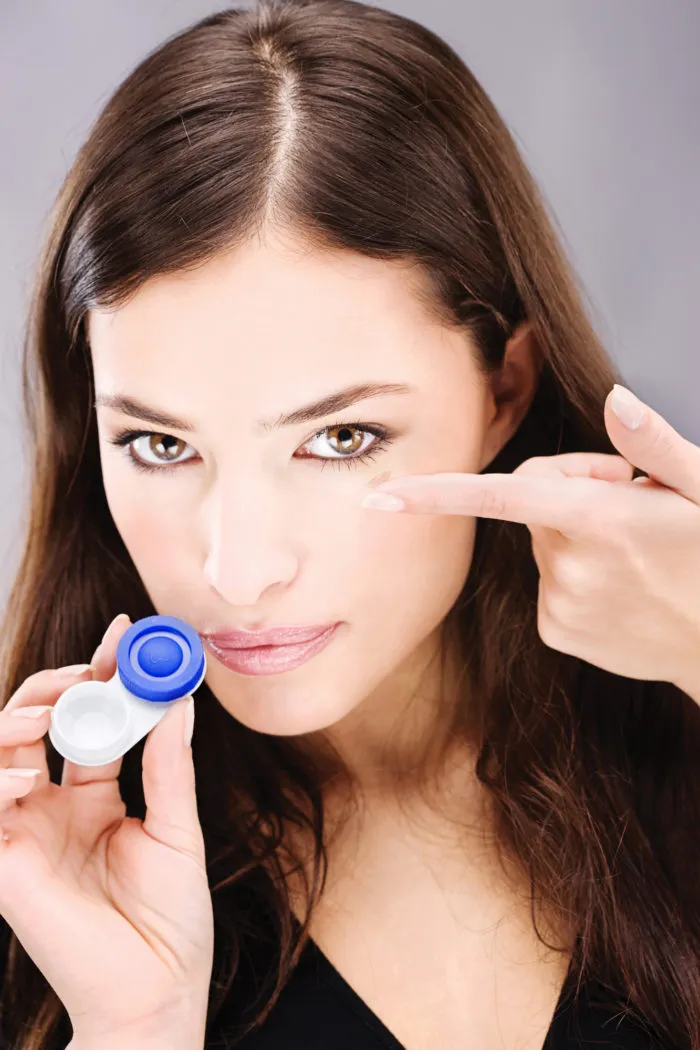woman holding contact lenses and case