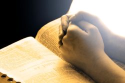 young person praying, hands close-up