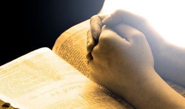 young person praying, hands close-up