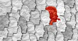 Artistic paper cut-out profiles of faces with one red face blowing a whistle among the crowd